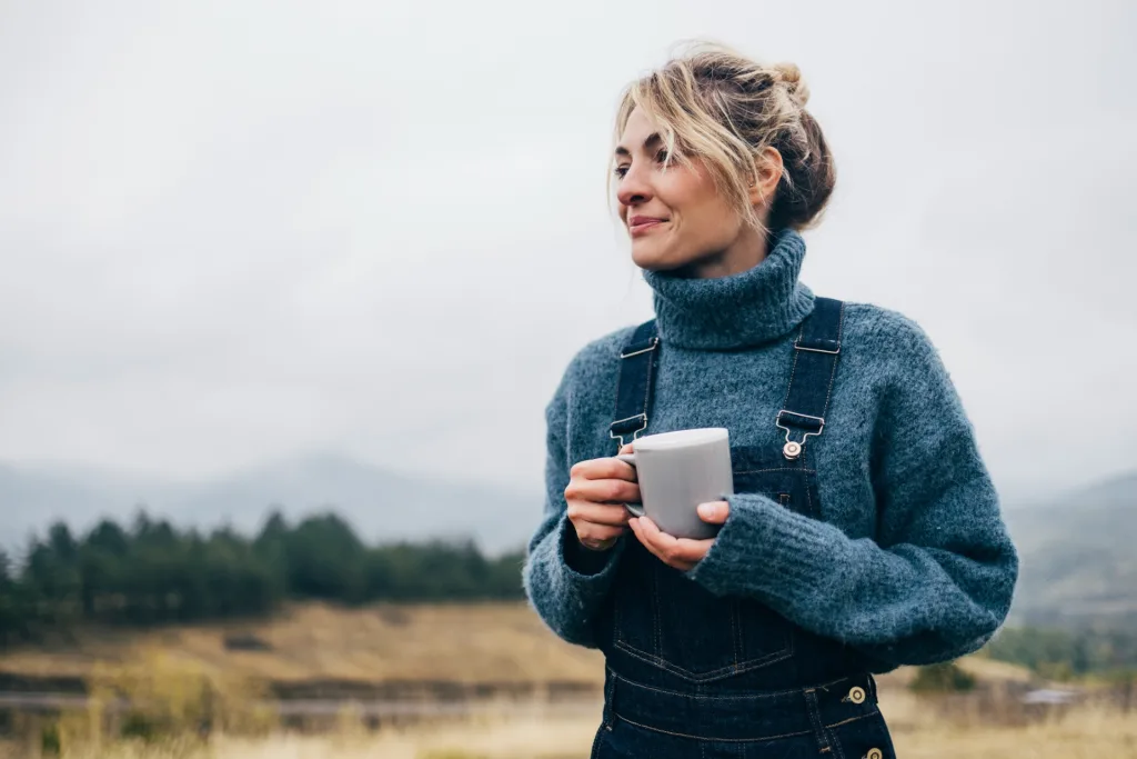 woman drinking tea in nature